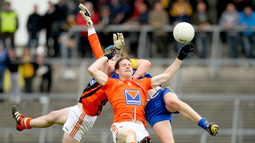 Armagh goalkeeper Philip McEvoy and defender Finnian Moriarty compete for a high ball with Niall Daly of Roscommon