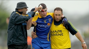Roscommon's Cathal Dineen leaves the field with a blood injury