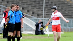 Derry's Alan Grant protests his innocence to the match officials at Casement Park
