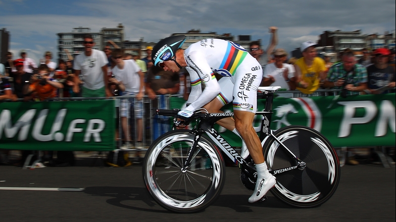 World time-trial champion Tony Martin is determined to continue despite the injury he picked up on Sunday