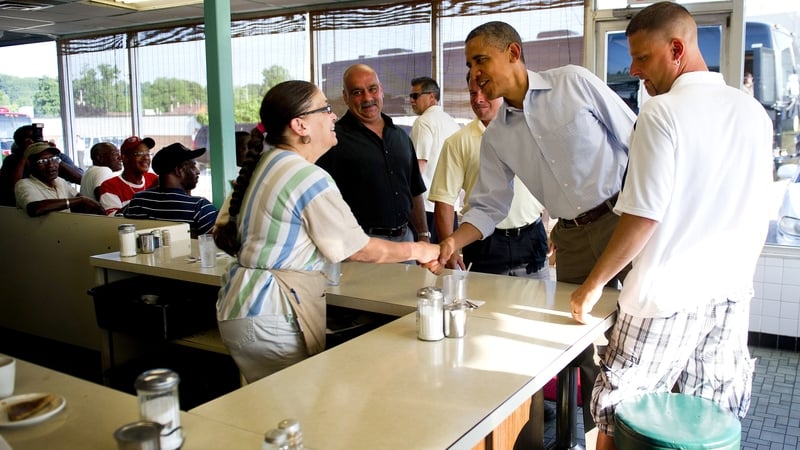 US President Barack Obama shakes hands with waitress Toni as he arrives at Ann's Place in Akron