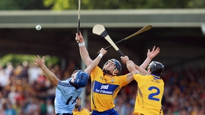 David Treacy competes for a high ball with Domhnall O'Donovan and Conor Cooney of Clare