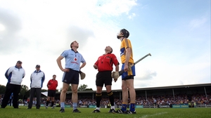 Captains Johnny McCaffrey and Patrick Donnellan and referee Diarmud Kirwan watch for the result of the pre-match coin toss
