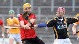 Antrim goalkeeper Padraig Nugent seeks to block Down's Caolan Bailie