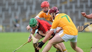 Antrim's Paddy Burke and Ryan Gillan surround Down's James McGrath in the drawn Ulster minor hurling final