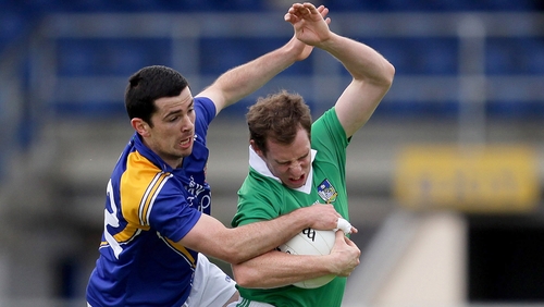 Francis McGee of Longford wrestles Limerick's Seanie Buckley for the ball at Pearse Park