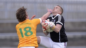 Antrim's Owen Gallagher challenges Galway goalkeeper Adrian Faherty