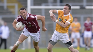 Antrim's Michael McCann chases Joe Bergin of Galway