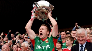 Andy Moran hoists the Nestor Cup above his head at Dr Hyde Park