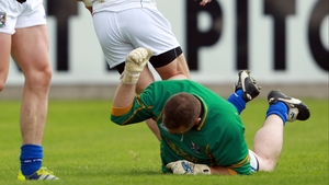Cavan goalkeeper Jame Reilly beats the ground in frustration as Emmet Bolton of Kildare scores the Lilywhites' second goal