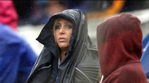 A Tipperary supporter tries to stay dry at Páirc Uí Chaoimh