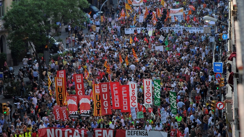 People protest during a demonstration organized by unions in Barcelona