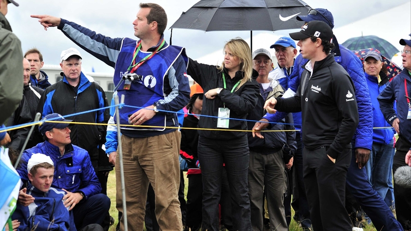 McIlroy is pointed in the direction of his ball, while Jason Blue (bottom left) nurses a sore head
