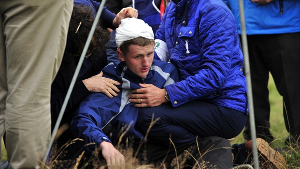 Jason Blue receives attention after he was struck by Rory McIliroy's ball yesterday