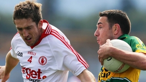 Kerry's Declan O'Sullivan (r) sidesteps Tyrone corner-back Dermot Carlin