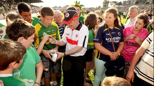 The ever-gracious Tyrone boss Mickey Harte signs autographs for Kerry fans after the game