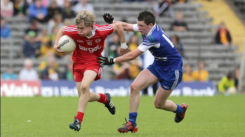 Shane Conlon of Monaghan in hot pursuit of Tyrone's Kieran McGeary in Clones