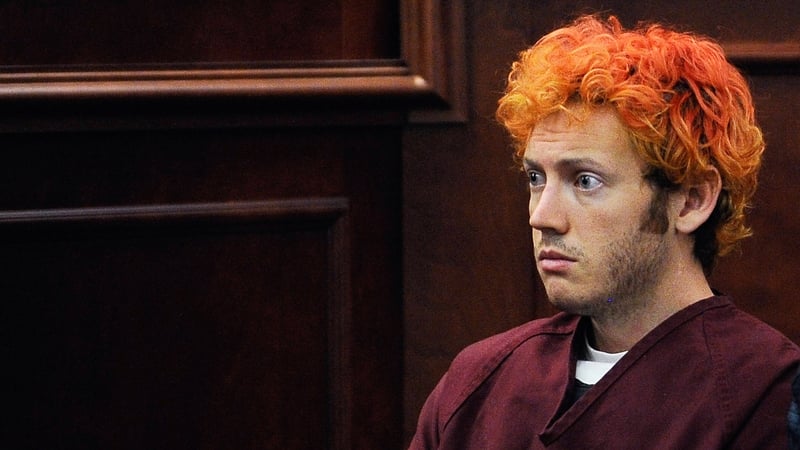 James Holmes was dressed in a red prison jump suit and dyed his hair red