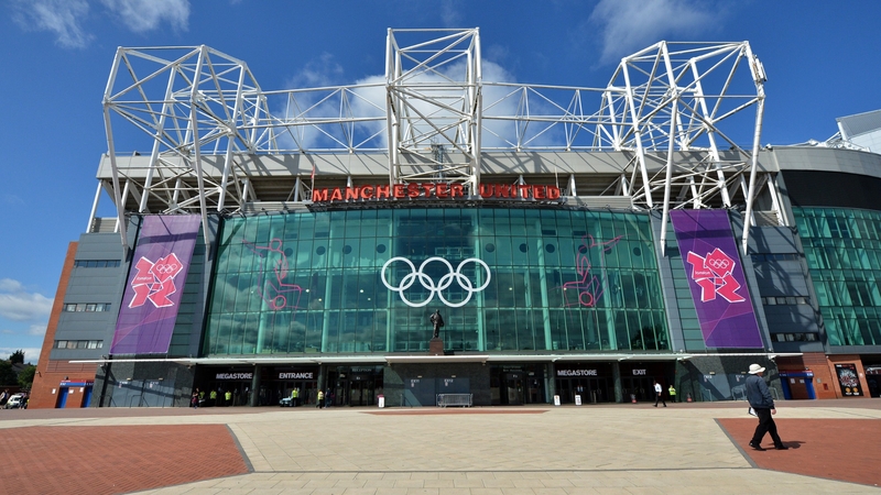 The Olympic Rings and the 2012 London Olympic Games logo are displayed outside Old Trafford stadium in Manchester