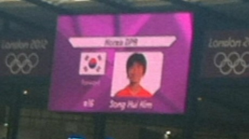 The South Korea flag alongside a member of the North Korea team