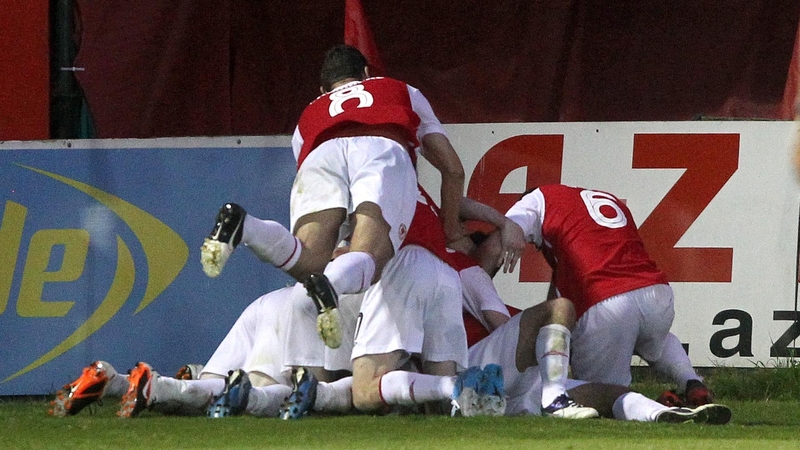Pat's players mob Christy Fagan after his injury time winner