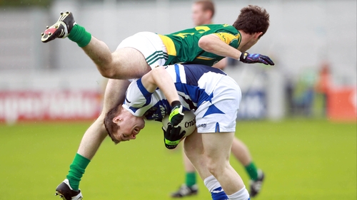 Meath's Donal Keogan goes over the top of Colm Kelly of Laois