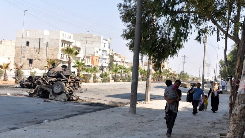 Syrian civilians leave their homes to safer areas during a lull in fighting between opposition forces and army troops in Aleppo