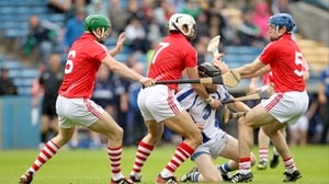 The Cork half-back line of Ó h'Ailpín (c), Tom Kenny (r) and Eoin Cadogan (l) converge on Kevin Moran of Waterford
