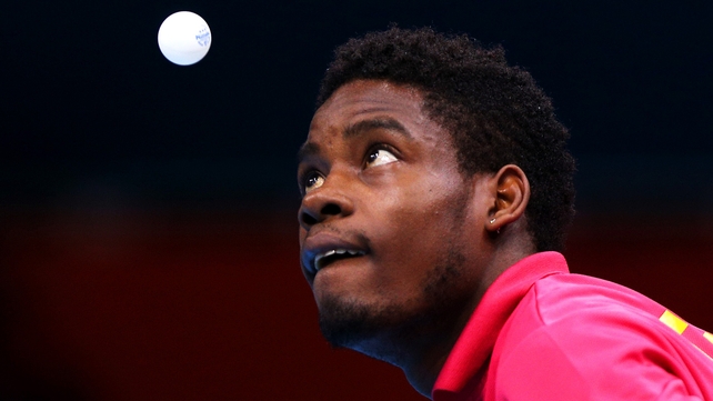Mawussi Agbetoglo of Togo serves against Justin Han of Australia during their men's singles preliminary round match