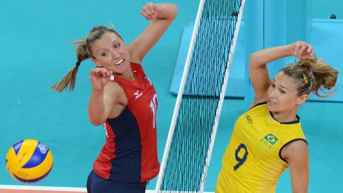 Brazil's Fernanda Ferreira (R) spikes the ball as US player Jordan Larson attempts to block in tonight's pool match