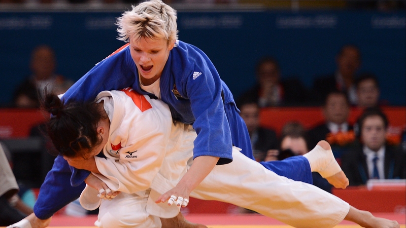 Slovenia's Urska Zolnir (blue) competes with China's Lili Xu