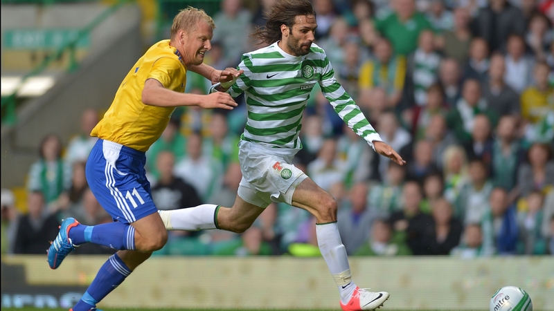 Georgios Samaras of Celtic goes around HJK's Mathias Lindstrom at Celtic Park