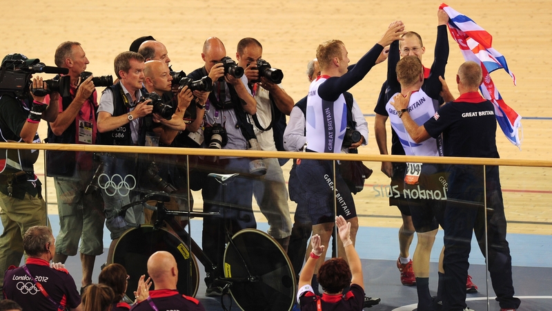 Chris Hoy and Philip Hindes are mobbed after winning gold in world record time
