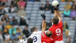 Kildare's Robert Kelly competes with Paudie Kissane and Aidan Walsh of Cork for a high ball