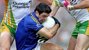 Aidan O'Mahony holds on for dear life as Donegal players converge on him