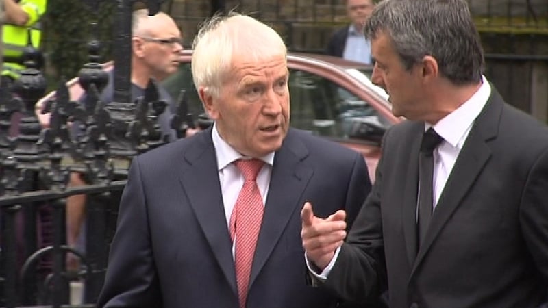 Minister for Arts Jimmy Deenihan walks into the church alongside Liam Mackey of the Irish Examiner