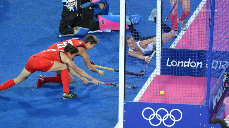 Carla Rebecchi of Argentina (R) dives to score a goal against Britain