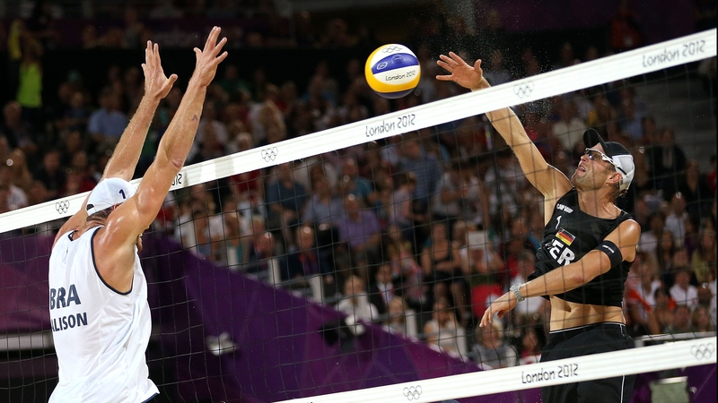 Julius Brink of Germany hits a return against Alison Cerutti