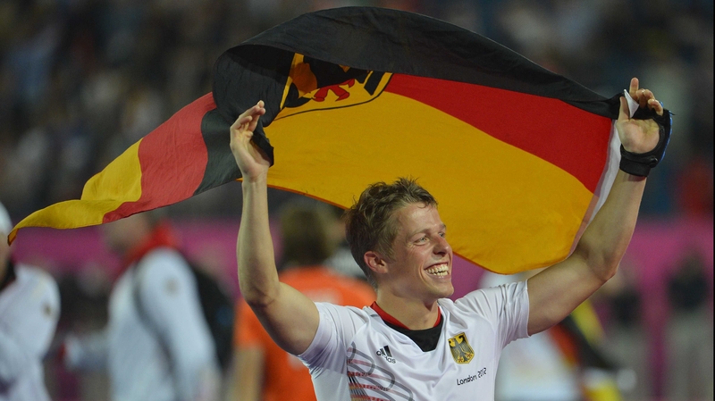 Germany's Timo Wess carries his national flag after the game
