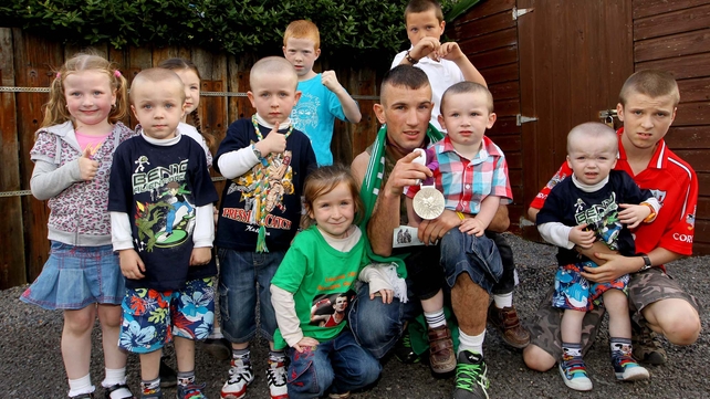 Boxer John Joe Nevin shows off his Olympic silver medal to his son and cousins