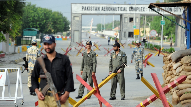 Pakistani Air Force personnel cordon the main entrance of the air force base following the attack in Kamra