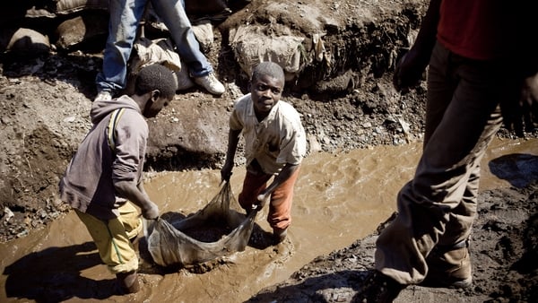 Children wash copper at an open-air mine in Kamatanda in the rich mining province of Katanga, Congo
