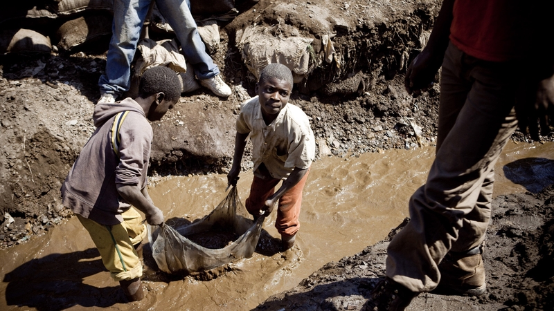 Children wash copper at an open-air mine in Kamatanda in the rich mining province of Katanga, Congo