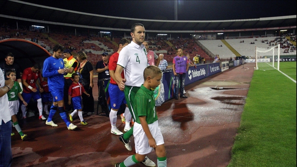 John O'Shea leads out the Republic of Ireland in Belgrade