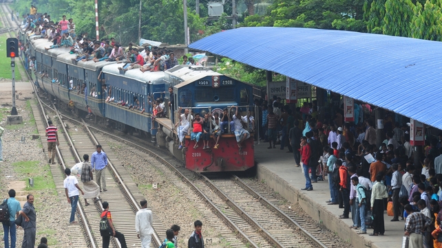 Bangladeshis ride on an overcrowded train as they rush home to be with their families in remote villages ahead of the Muslim festival of Eid al-Fit