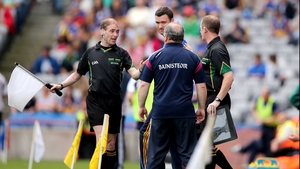 Sideline officals separate Galway manager Matt Murphy and Tipperary boss Willam Maher