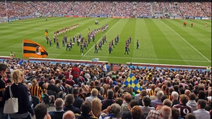 Tipperary and Kilkenny players walk behind the band during the pre-match parade