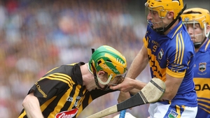 Tipperary's Shane McGrath pulls off the helmet of Richie Power of Kilkenny