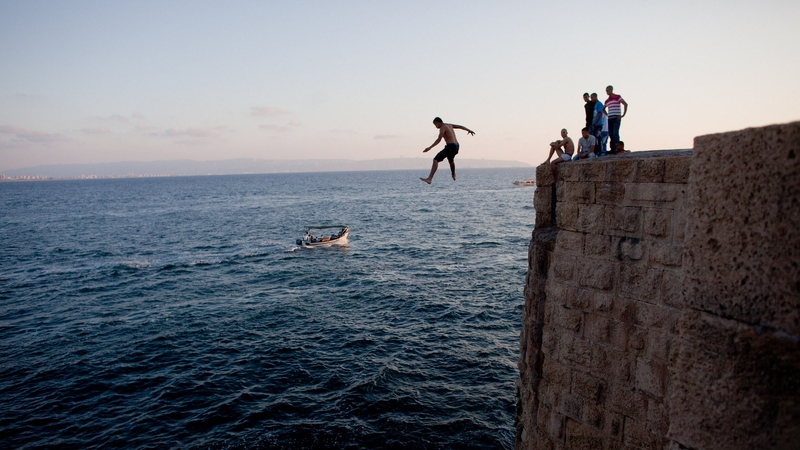 An Israeli Arab jumps to the sea from the walls of the old city in Acre as Muslims celebrated the Eid al-Fitr holiday