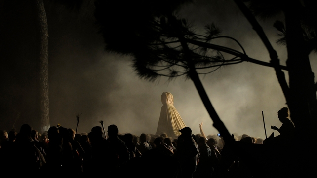 People gather around a statue of the Virgin del Rocio during the El Rocio Romeria pilgrimage in Huelva, Spain